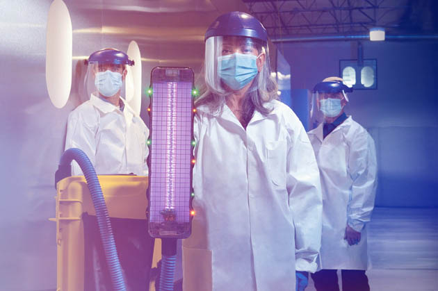 UV THREE: (From left) Boeing engineers Kevin Callahan, Teresa King and Jamie Childress with the UV wand at Boeing’s Concept Center in Everett, Washington. They led a team that turned a concept into a device that could change the way airplanes are sanitized. 