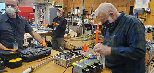 WORKSHOP IT: (Left to right) UV team members Kevin Callahan, Jamie Childress and Art Brockschmidt work during the duct tape stage of the UV wand development at Boeing's Concept Center in Everett, Washington.  